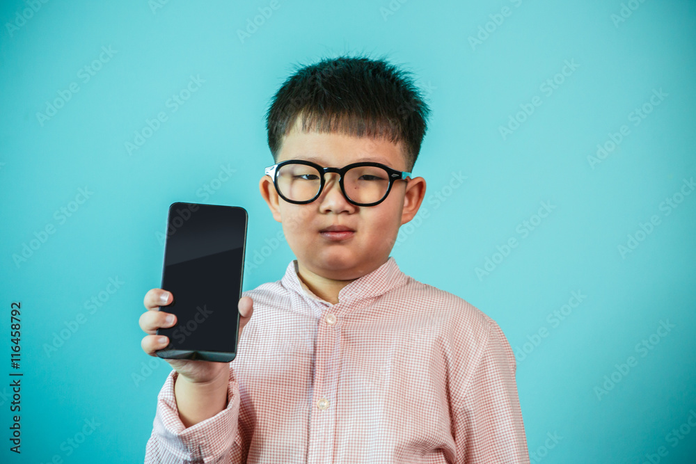Asian boy with smartphone at home playing Asian boy with smartphone at home playing