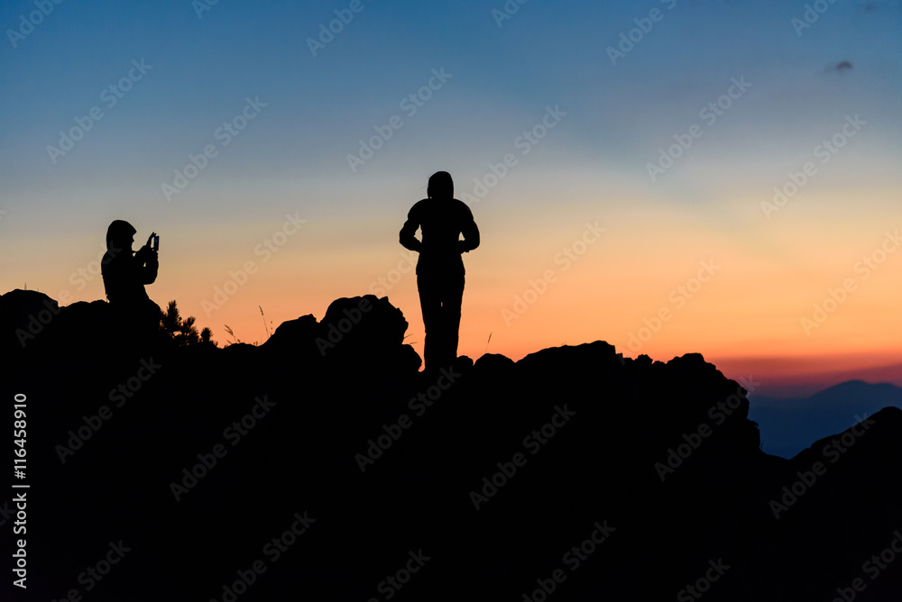 Silhouette of a couple taking self portraits, enjoying the sunset at Vitosha Mountain, Bulgaria
