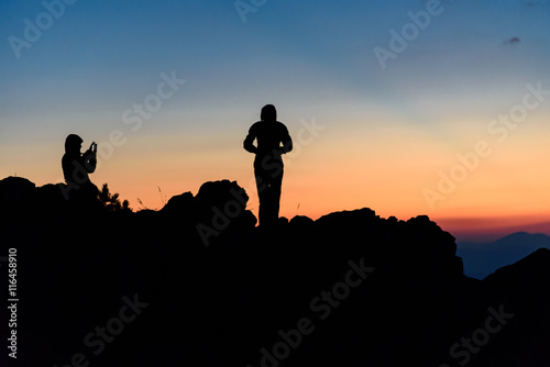 Silhouette of a couple taking self portraits  enjoying the sunset at Vitosha Mountain  Bulgaria