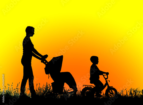 silhouette mother with children walking at sunset