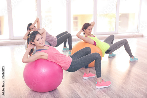Young women doing exercise with ball