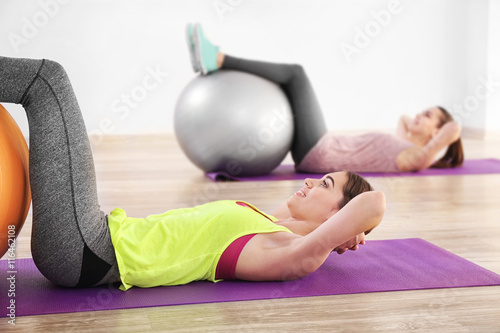 Young women doing exercise with ball