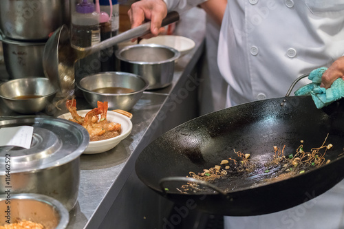 Detail of a line chef preparing Chinese food
