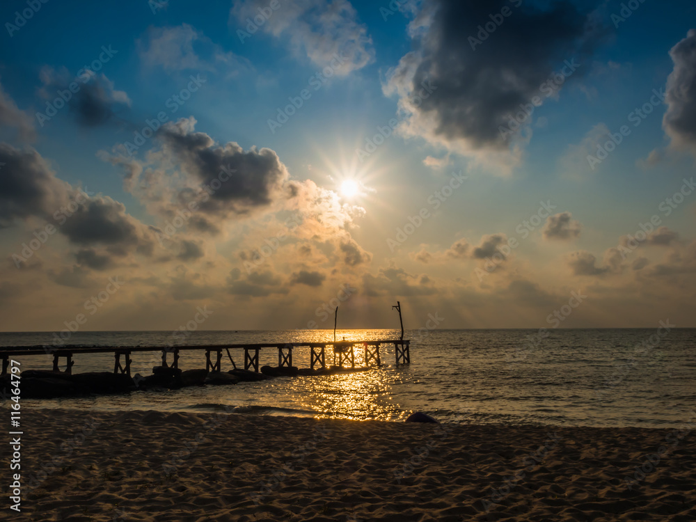Wooded bridge to the sea between sunset Wooded bridge to the sea between sunset