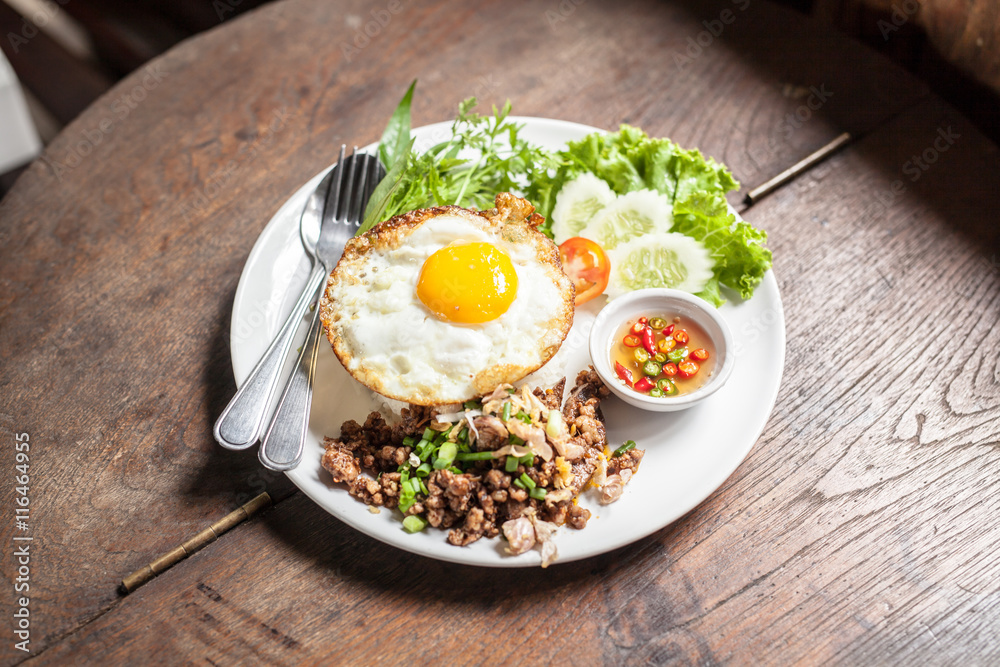 Fried egg with rice on wooden table Fried egg with rice on wooden table