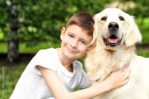 Small boy and cute dog in park
