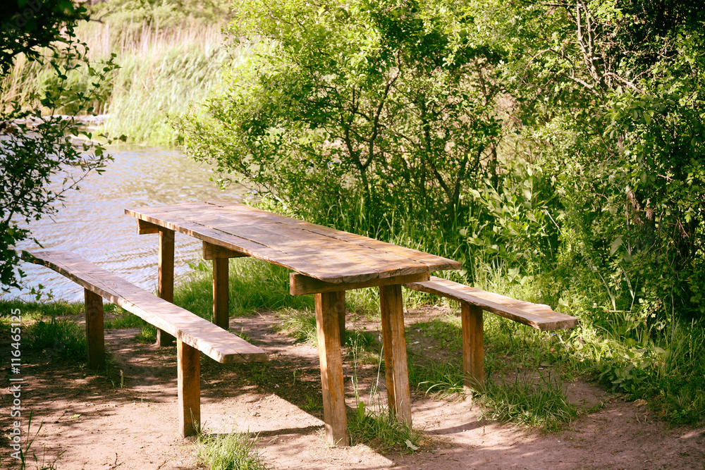 Fototapeta premium Bench and table in a tranquil landscape