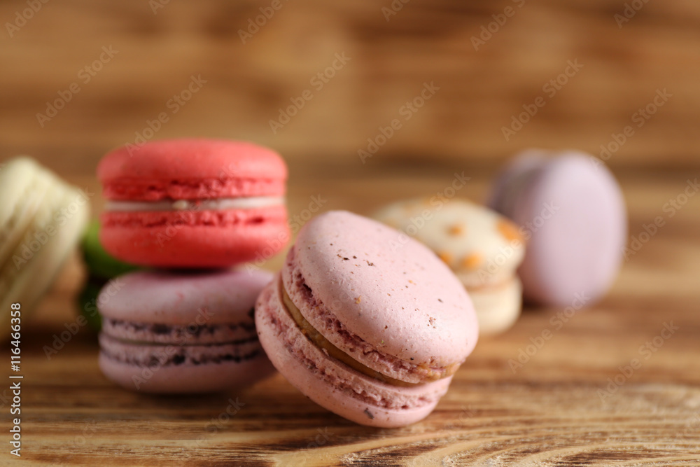 Heap of tasty macaroons on wooden background Heap of tasty macaroons on wooden background