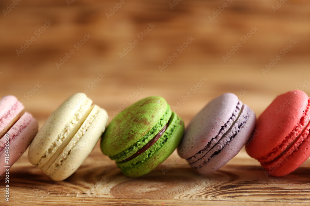Colorful tasty macaroons on wooden background Colorful tasty macaroons on wooden background