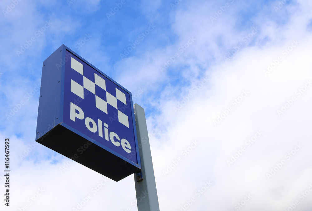 blue and white police station sign in bright blue sky blue and white police station sign in bright blue sky