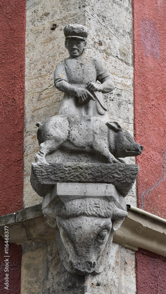 stone sculpture at the corner of the old house