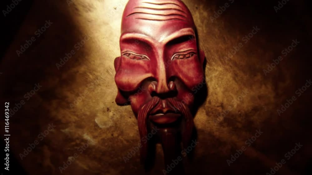 Gentle Light Moves on Mongolian Wooden Mask in the Dark Closeup Gentle Light Moves on Mongolian Wooden Mask in the Dark Closeup