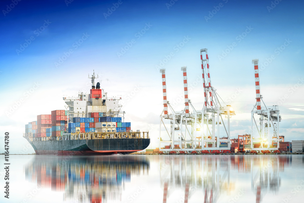 Logistics and transportation of International Container Cargo ship in a harbor with water reflections for logistic import export background and transport industry.