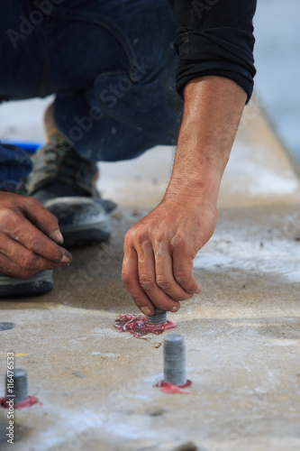 Setting stud bolt into adhesive chemical anchor