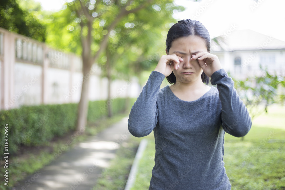 Woman crying at park Woman crying at park