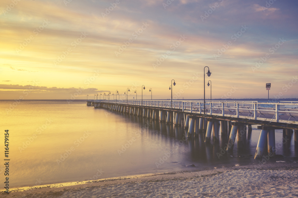 Naklejka premium wooden pier on the Baltic Sea, Gdynia Orłowo, Poland.Seascape,sunset, retro effect