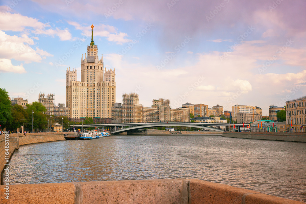 Fototapeta premium Beautiful Stalin skyscraper, Moscow river and river boats. Moscow city landscape in the city center, Russia