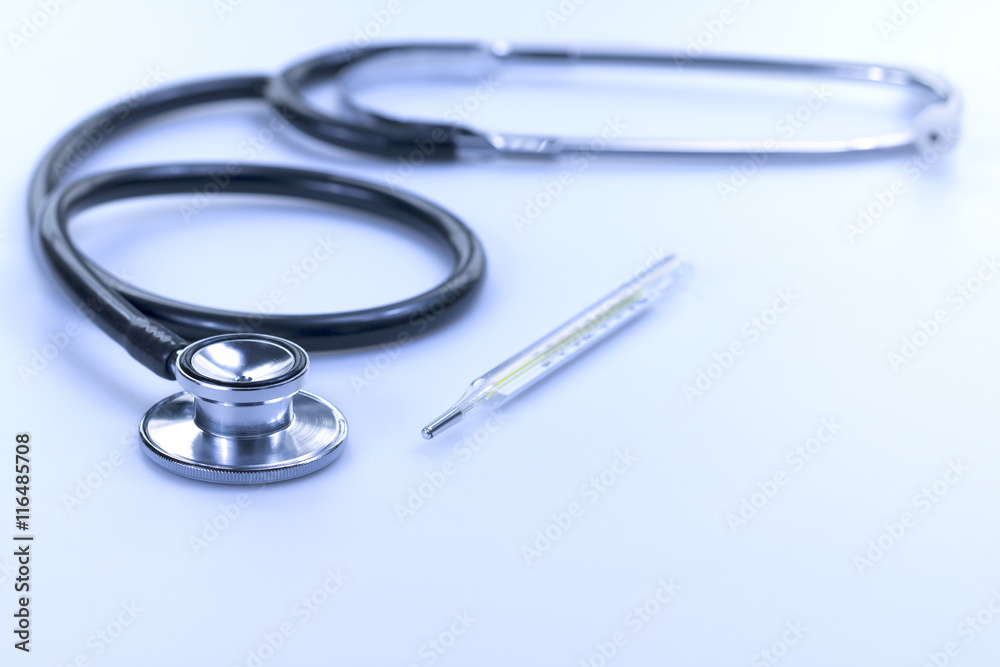 Stethoscope and Thermometer Isolated in Blue White-balance Stethoscope and Thermometer Isolated in Blue White-balance