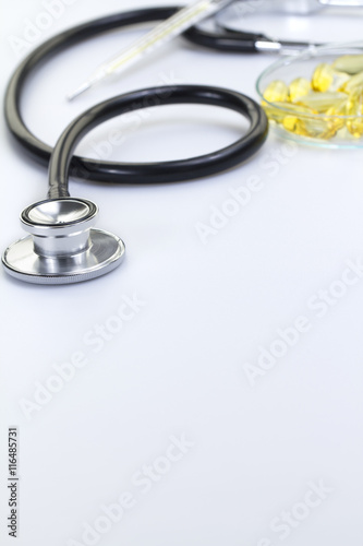 Stethoscope with Thermometer and Medicine Isolated on White photo