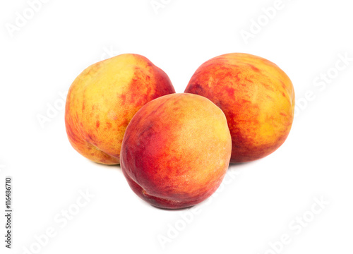 Three fresh peaches