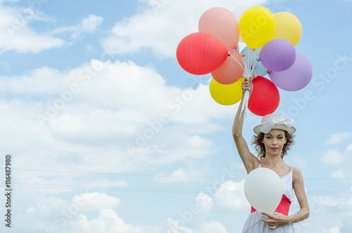 girl with a balloon flying in the clouds