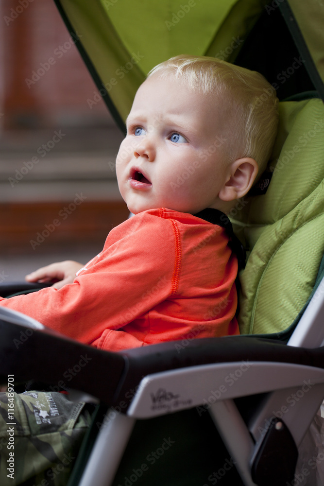 Little boy sitting in stroller Little boy sitting in stroller