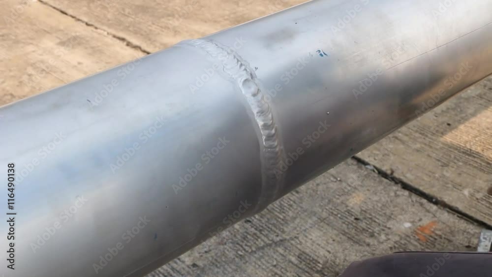 Aluminum pipe cleaning surface. After welding is finished with a brushed steel, polished surface. Aluminum pipe cleaning surface. After welding is finished with a brushed steel, polished surface.
