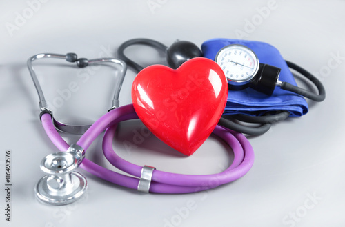 Medical instruments and red heart for ENT doctor on white photo