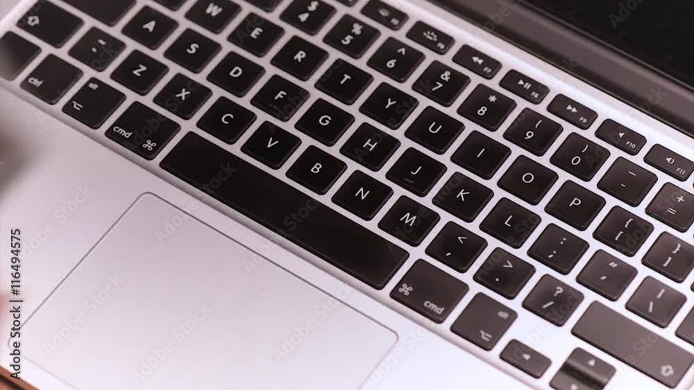 Woman throws the US dollar banknotes on keyboard of laptop computer. Female hands of accountant or housewife with money bills and notebook.