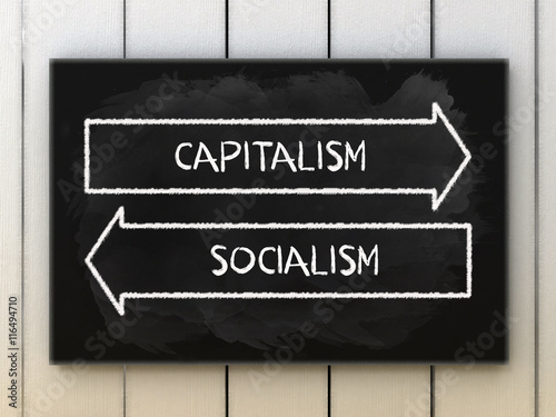 Capitalism or socialism choices on black board written with chalk. photo