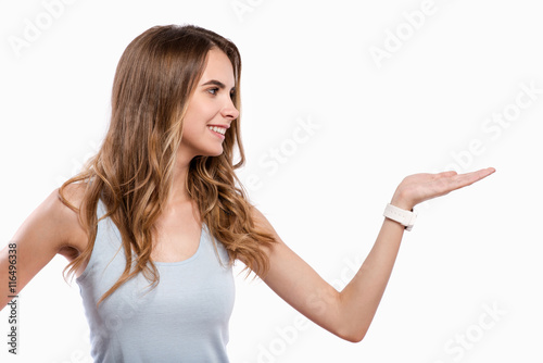 Positive delighted woman pointing left