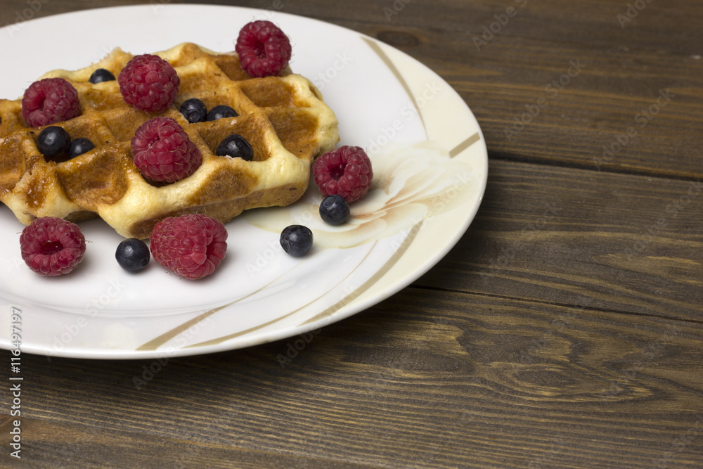 waffles in a white plate with berries waffles in a white plate with berries