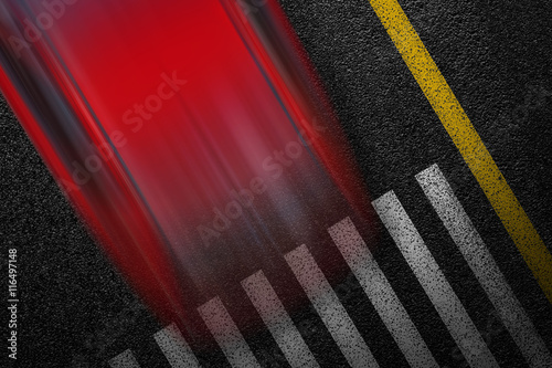 Level asphalted road with a dividing stripes, pedestrian crossing and moving with high speed a red car. The texture of the tarmac, top view.