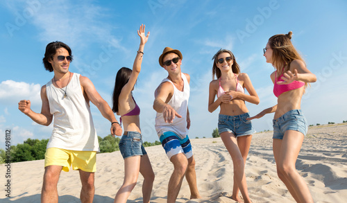 Joyful friends having fun on the beach