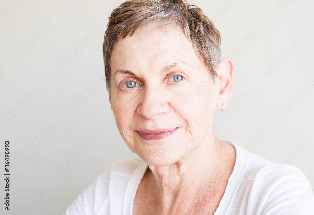 Portrait of older woman with short hair and white top Portrait of older woman with short hair and white top