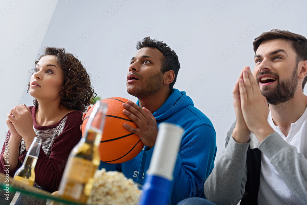 Friends watching sport on TV