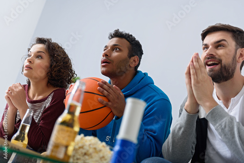 Friends watching sport on TV