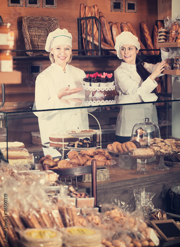 Cafe staff offering cakes