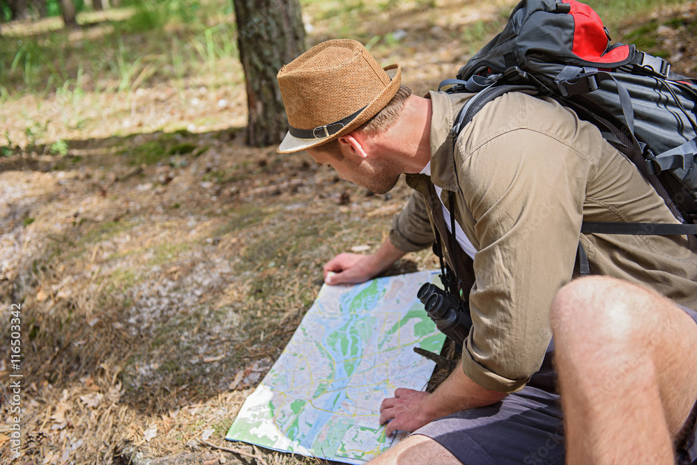 Male tourist navigating in nature