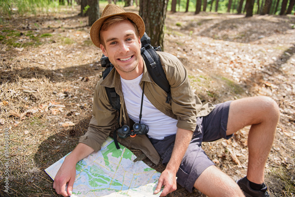 Joyful male adventurer searching for location Joyful male adventurer searching for location