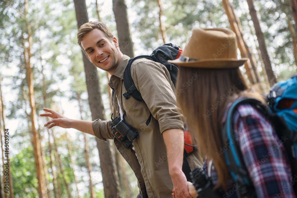 Carefree loving couple traveling in forest