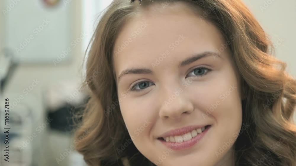 Brown-haired without make up smiling on the camera