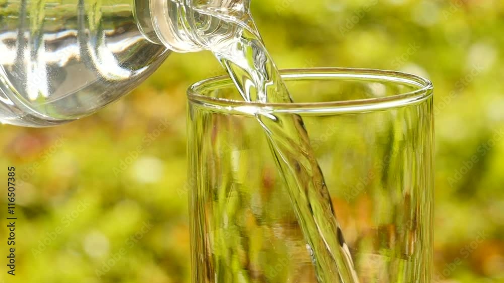 Drink water pouring in to glass over morning sunligh Drink water pouring in to glass over morning sunligh