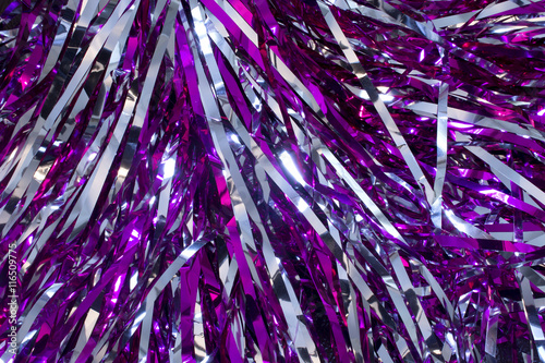 This is a closeup photograph of Cheerleader silver and purple pom poms