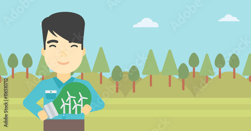 Man holding lightbulb with windmills inside.