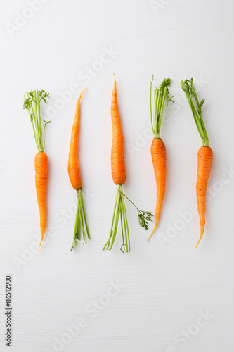 young carrots top view on white background