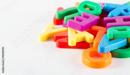 Colorful plastic alphabet letters on white background
