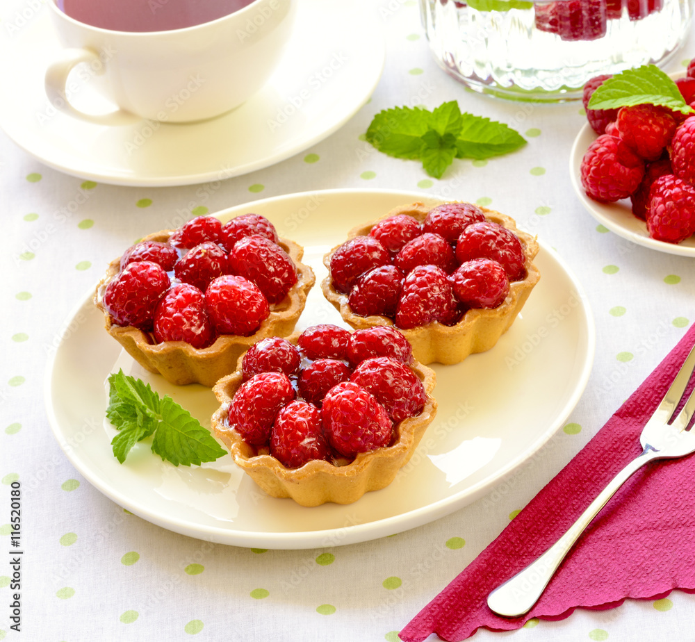 Fruit raspberry tart cakes on a table Fruit raspberry tart cakes on a table
