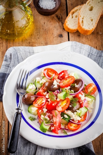 salad with tomatoes, cucumbers, olives, onions, feta and couscous