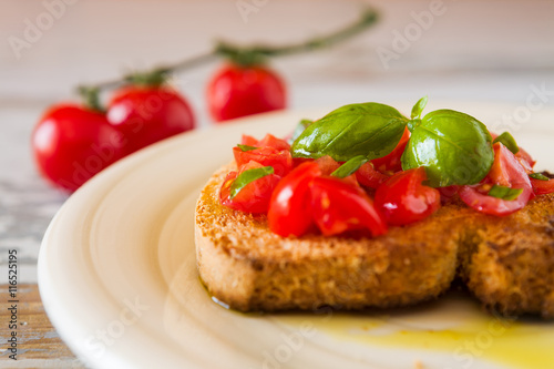 Closeup of bruschetta with tomato and basil